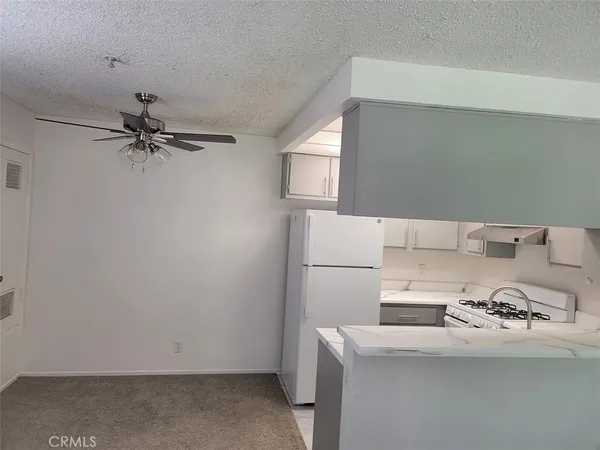 a kitchen with a stove and a refrigerator