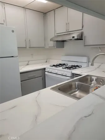 a kitchen with a sink stove and cabinets