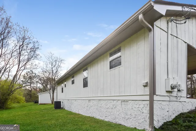 a white house with tree in front of it