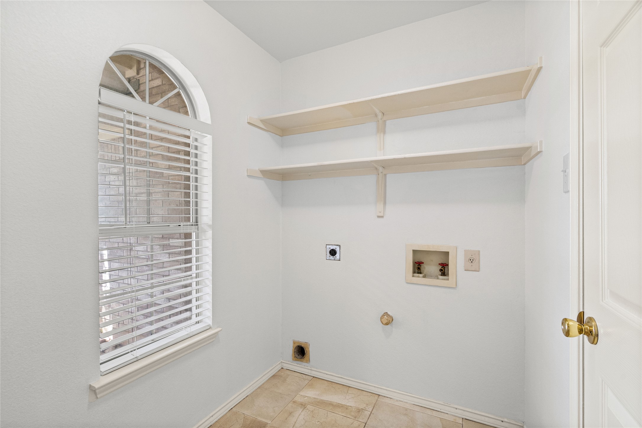 2920 Warwick Way Austin, TX 78748 - Photo 28 of 36 A dedicated laundry room features convenient shelving and a window with blinds for natural light