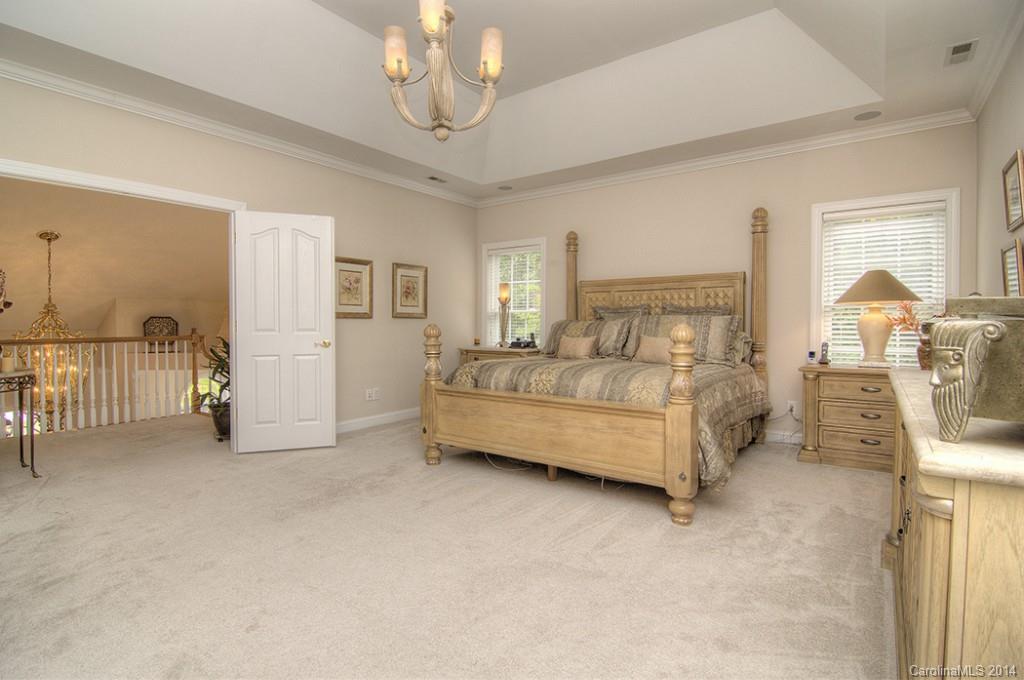 3237 Planters Ridge Road Charlotte, NC 28270 - Photo 14 of 24 a bedroom with bed and a chandelier
