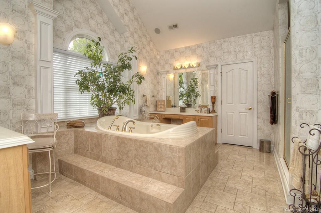 3237 Planters Ridge Road Charlotte, NC 28270 - Photo 15 of 24 a bathroom with a tub sink and mirror