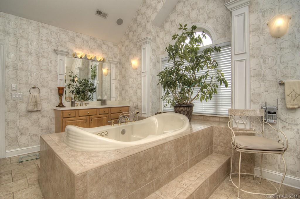 3237 Planters Ridge Road Charlotte, NC 28270 - Photo 16 of 24 a bath tub sitting in a bathroom next to a sink