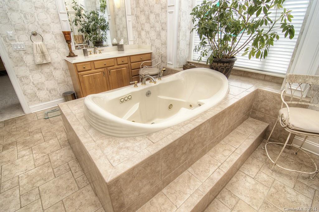 3237 Planters Ridge Road Charlotte, NC 28270 - Photo 17 of 24 a bathroom with a bathtub and sink