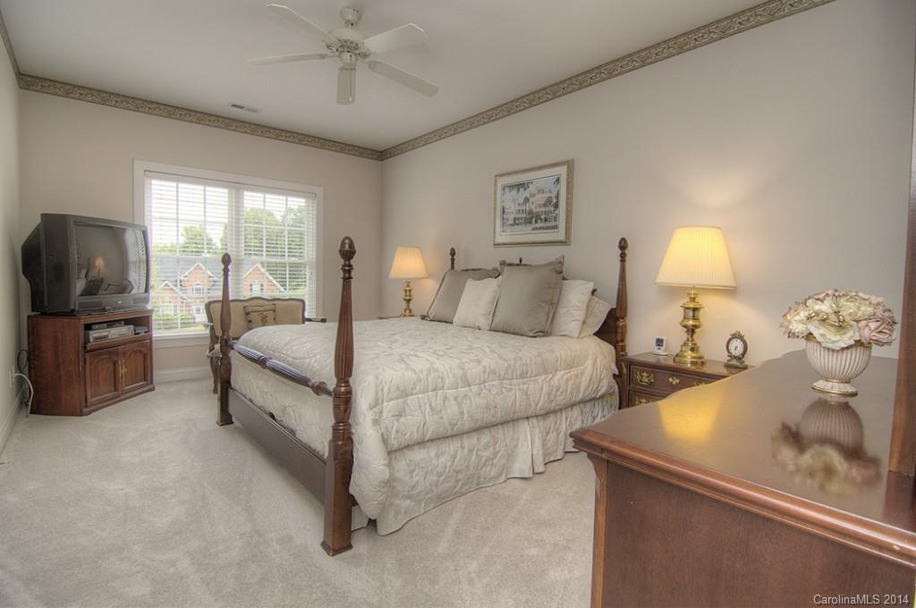 3237 Planters Ridge Road Charlotte, NC 28270 - Photo 18 of 24 a bedroom with a bed and a flat tv screen on dresser