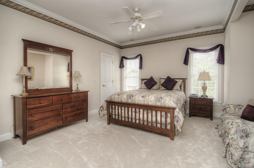 3237 Planters Ridge Road Charlotte, NC 28270 - Photo 20 of 24 a bedroom with a large bed and a dresser