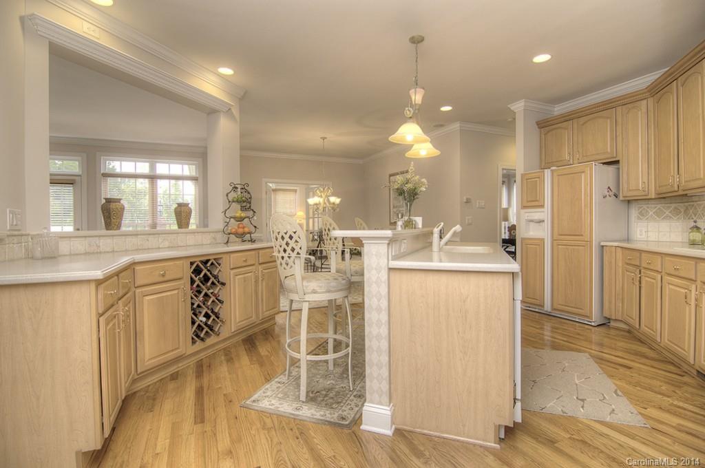 3237 Planters Ridge Road Charlotte, NC 28270 - Photo 7 of 24 a kitchen with a refrigerator a sink and cabinets