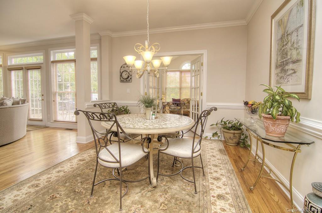 3237 Planters Ridge Road Charlotte, NC 28270 - Photo 9 of 24 a view of a dining room with furniture and wooden floor
