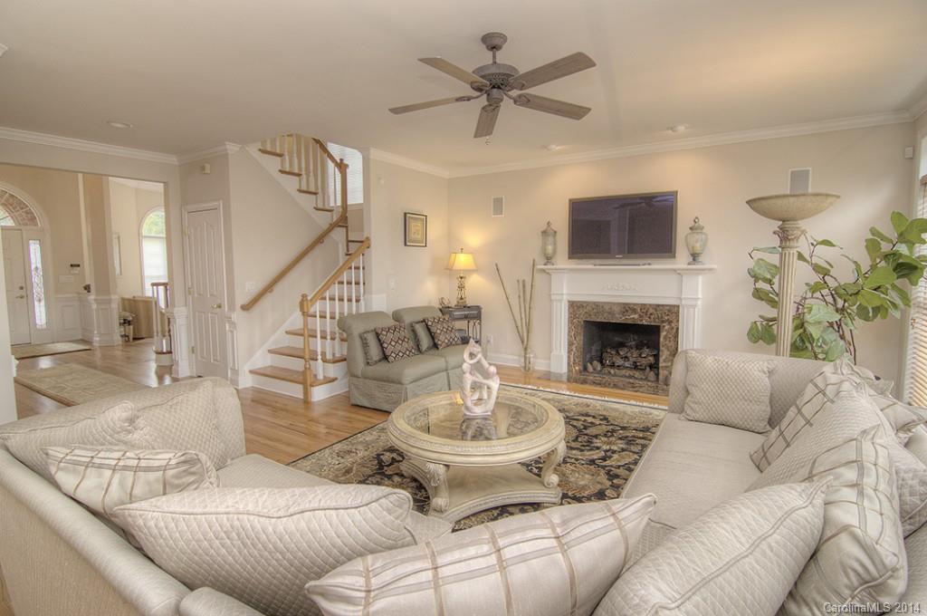 3237 Planters Ridge Road Charlotte, NC 28270 - Photo 10 of 24 a living room with furniture a fireplace and a flat screen tv