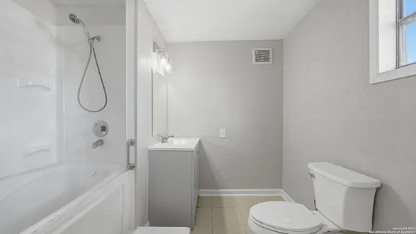 a bathroom with a bathtub and window