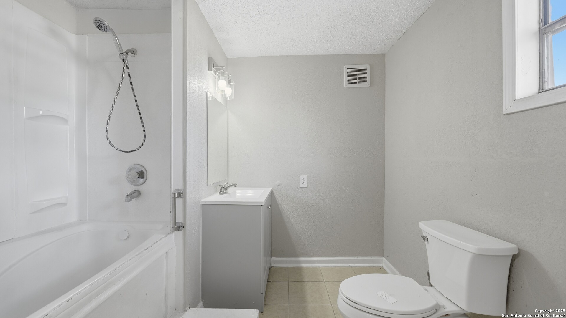 13895 Wisdom Road Atascosa, TX 78002 - Photo 12 of 48 a white toilet sitting next to a bath tub shower