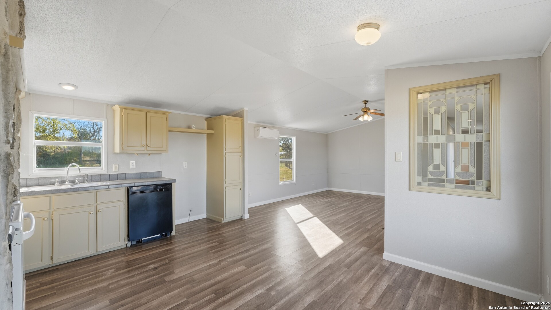 13895 Wisdom Road Atascosa, TX 78002 - Photo 22 of 48 a kitchen with a wooden floor and window