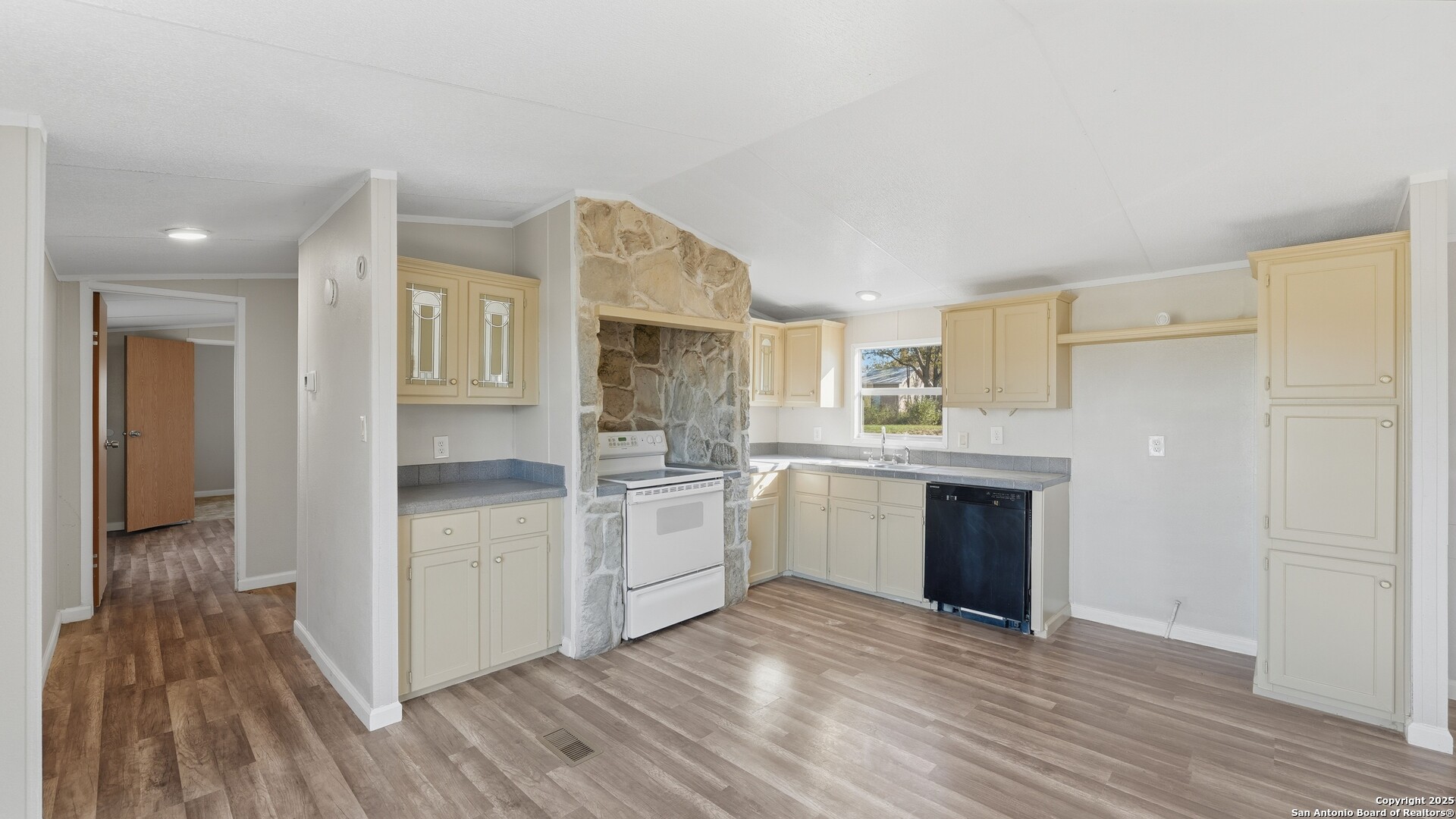 13895 Wisdom Road Atascosa, TX 78002 - Photo 23 of 48 a kitchen with a sink cabinets stainless steel appliances and a window