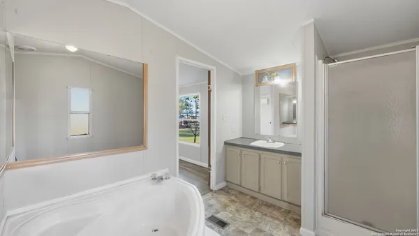 a bathroom with a bathtub and shower