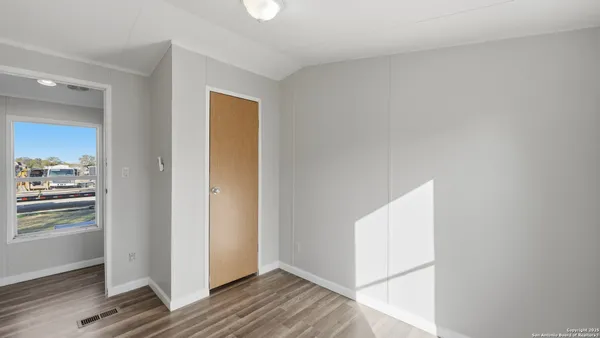 a view of room with window and hardwood floor