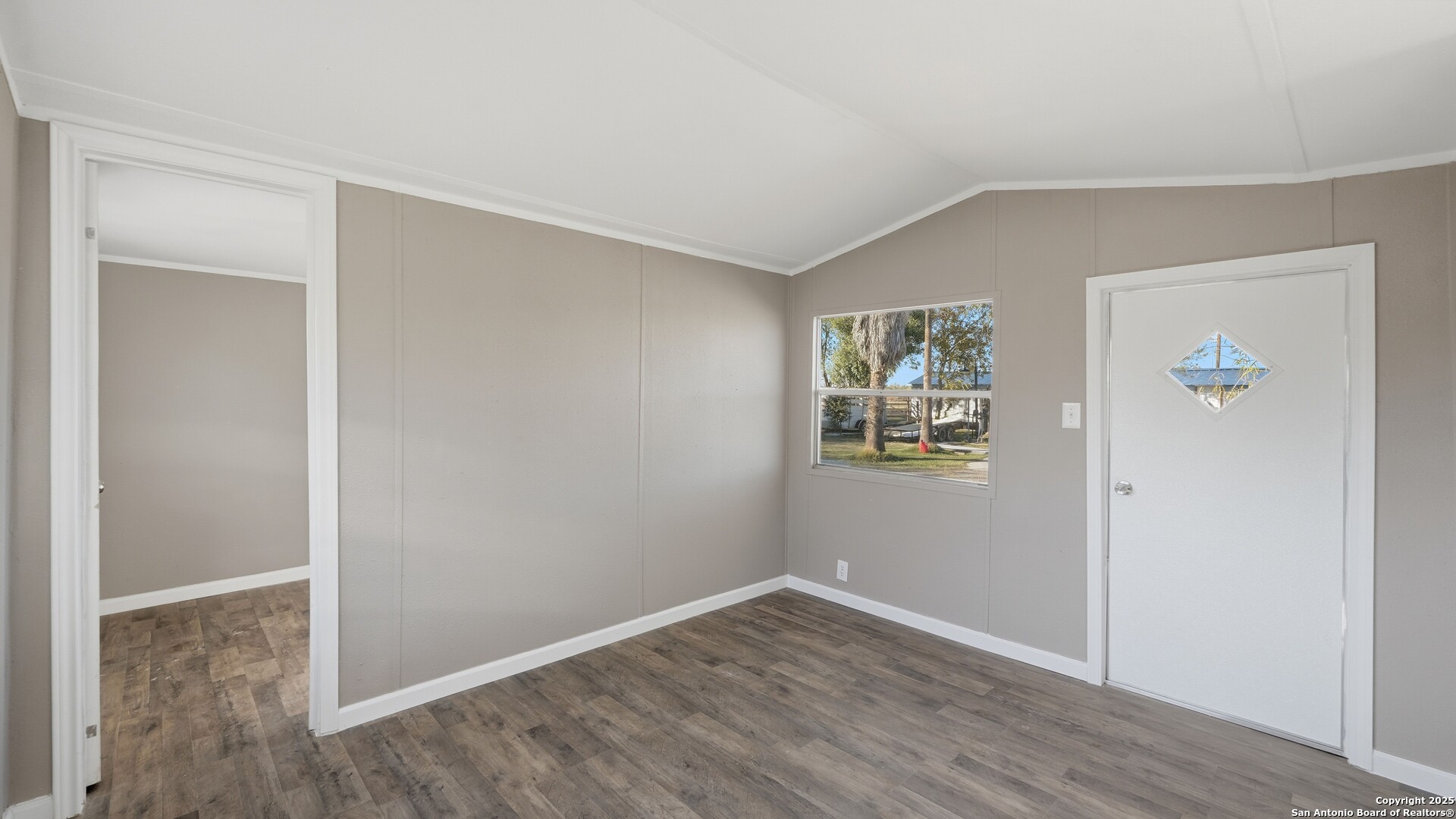 13895 Wisdom Road Atascosa, TX 78002 - Photo 35 of 48 a view of an empty room with wooden floor and a window