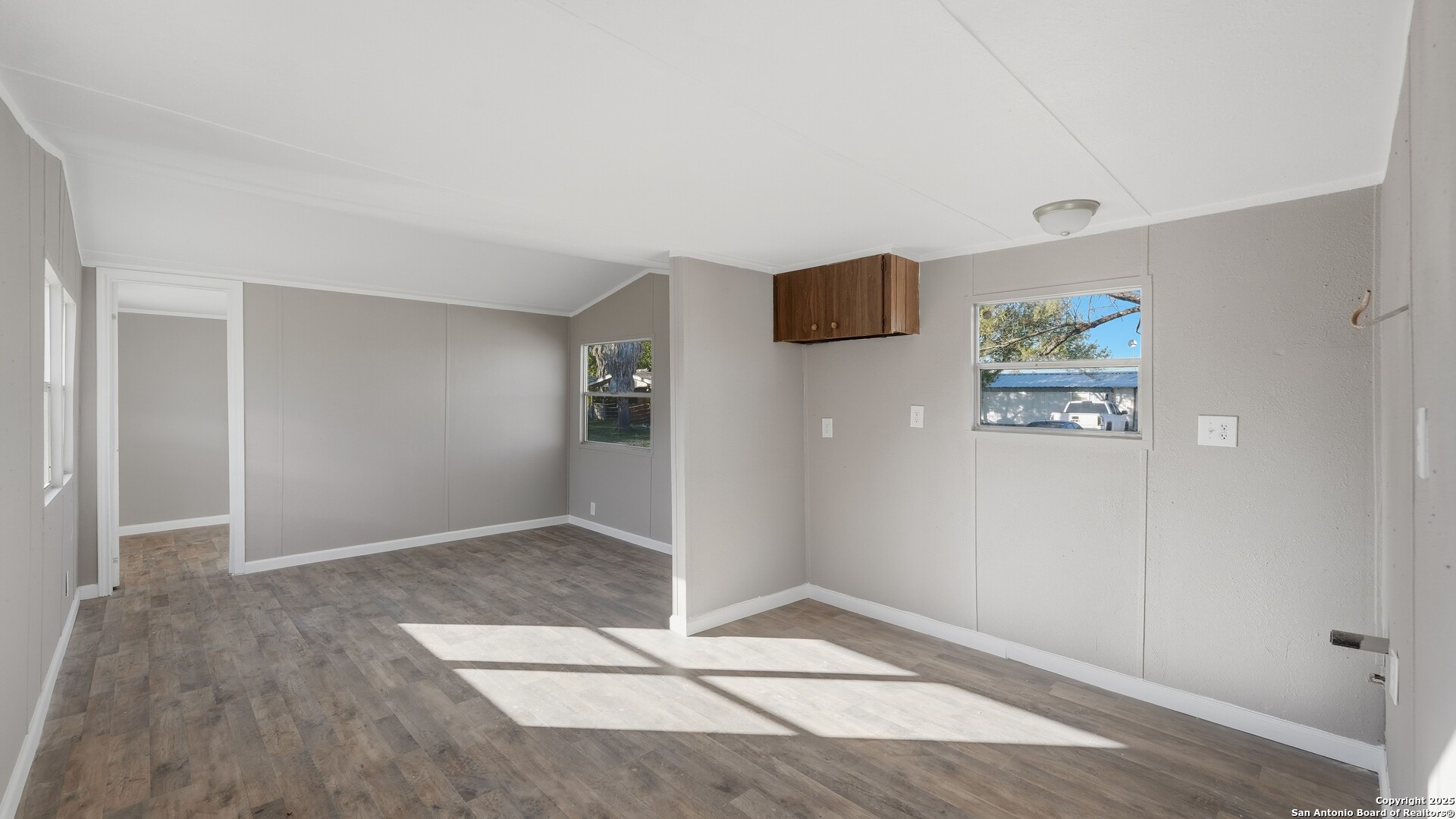 13895 Wisdom Road Atascosa, TX 78002 - Photo 38 of 48 an empty room with wooden floor and windows