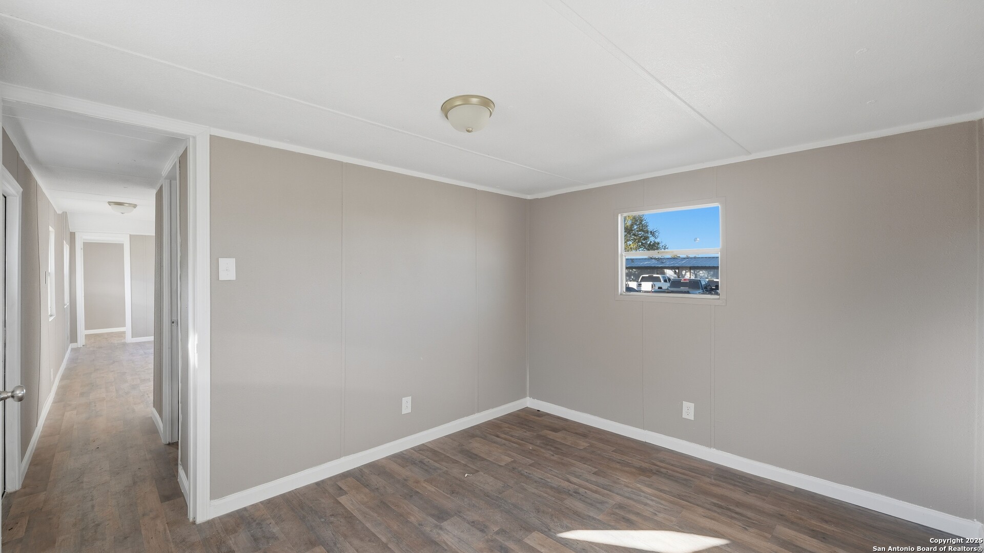 13895 Wisdom Road Atascosa, TX 78002 - Photo 43 of 48 a view of an empty room with wooden floor and a ceiling fan