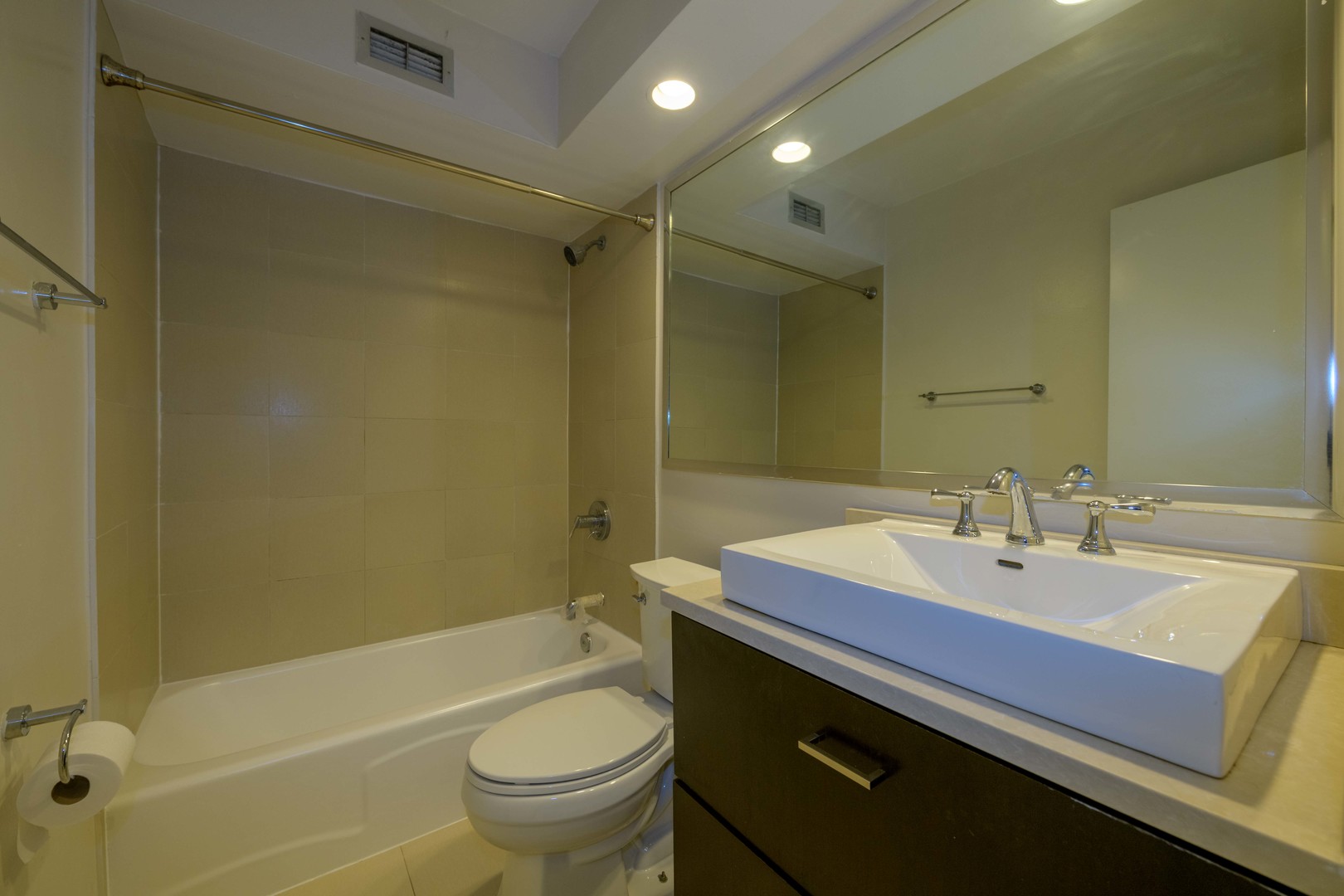 3033 North Sheridan Road, Unit 711 Chicago, IL 60657 - Photo 8 of 11 a bathroom with a sink a toilet and shower