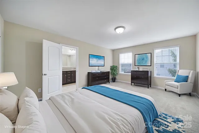 a spacious bedroom with a bed and furniture