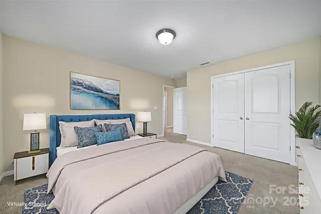 a bedroom with a large bed and a potted plant