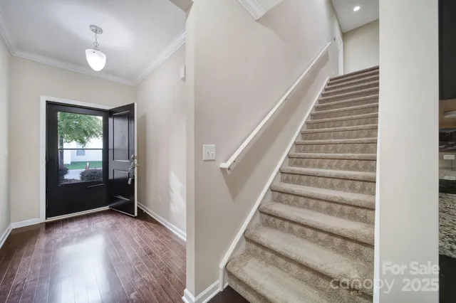 a view of entryway with stairs and wooden floor