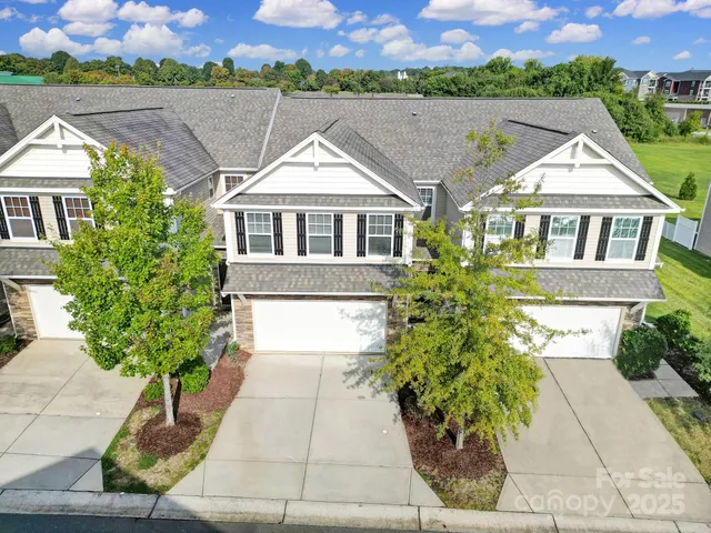 an aerial view of a house with garden space and street view