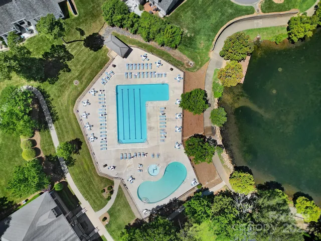 an aerial view of residential houses with outdoor space and river