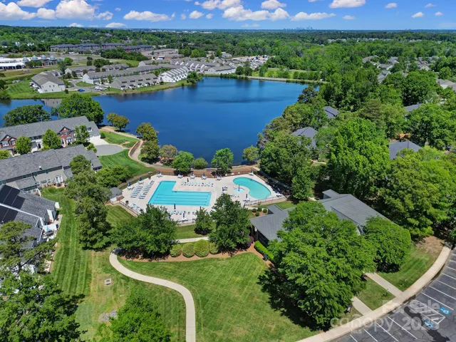 an aerial view of a house with a yard and lake view