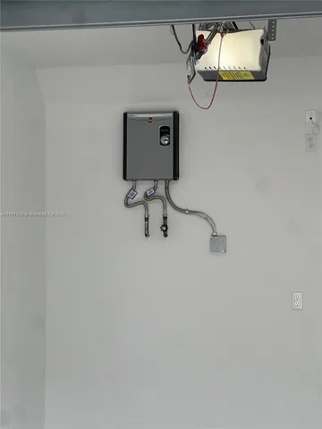 a large kitchen with kitchen island granite countertop a stove a sink a refrigerator a stove top oven and a sink with wooden floor