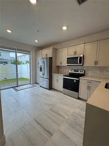 a view of a livingroom with a ceiling fan a ceiling fan and wooden floor