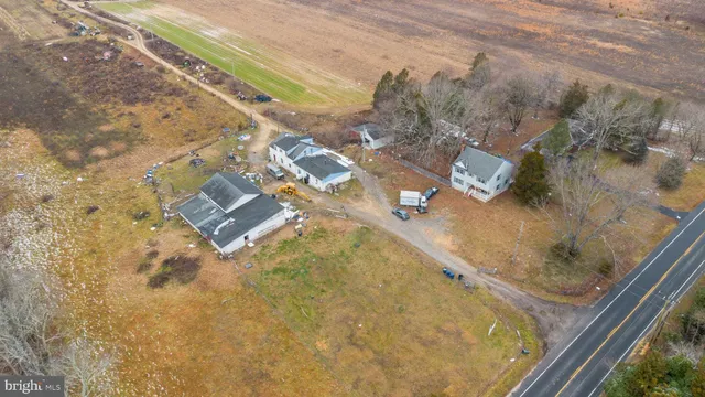 a view of a dry yard with wooden fence