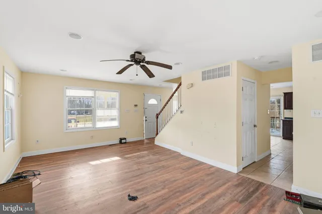 a bathroom with a toilet a sink a bath tub and mirror