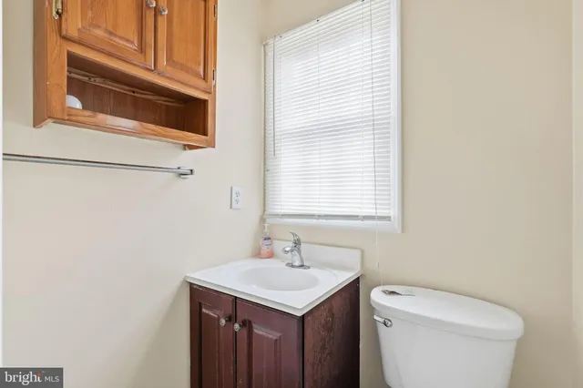 a view of an empty room with closet and a window