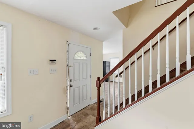 a view of a house with cars parked