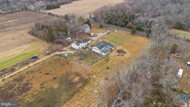 an aerial view of a house with a yard and wooden fence
