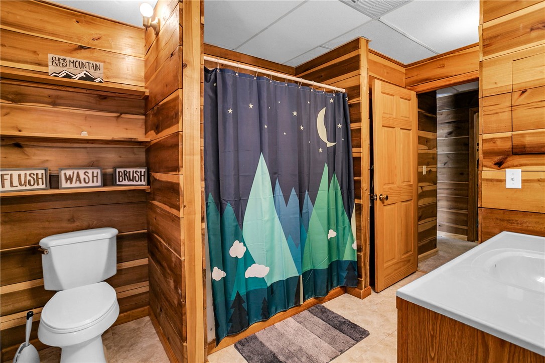 130 Greenbrier Road Salem, SC 29676 - Photo 14 of 48 This cozy bathroom features warm wood paneling and practical design.