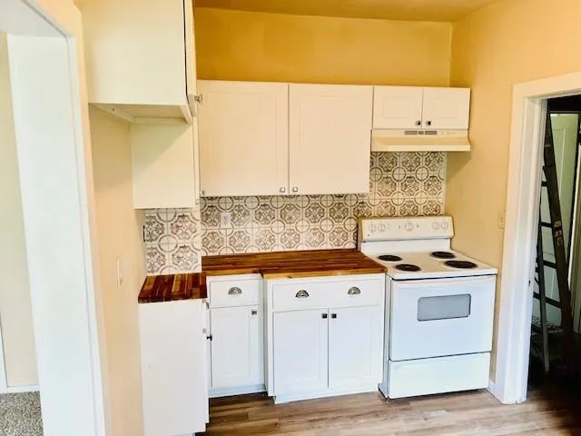 a kitchen with a stove and a refrigerator
