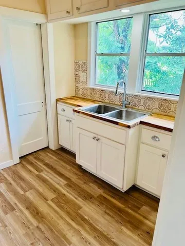 a kitchen with a sink and large window
