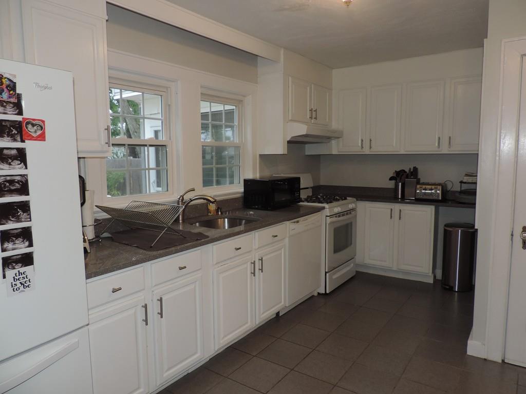 24 Partridge Road Weymouth, MA 02190 - Photo 5 of 24 a kitchen with granite countertop white cabinets and white appliances
