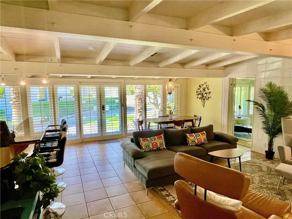 a living room with furniture and a floor to ceiling window