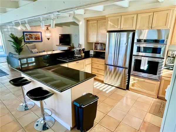 a kitchen with stainless steel appliances a stove a microwave and a refrigerator