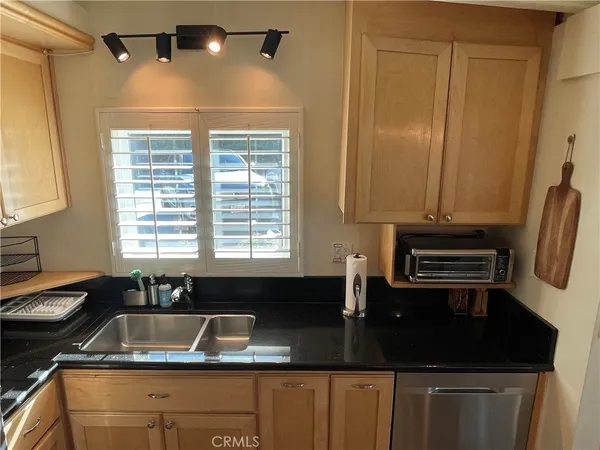 a kitchen with a sink a counter space and a window