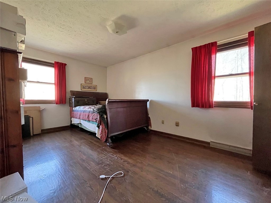 11524 Easton Road Rittman, OH 44270 - Photo 11 of 16 Unfurnished bedroom featuring a textured ceiling and dark wood-type flooring