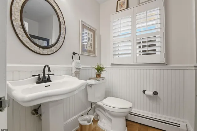 a bathroom with a sink a mirror and a toilet