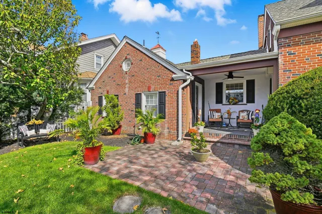 a view of a house with backyard sitting area and garden