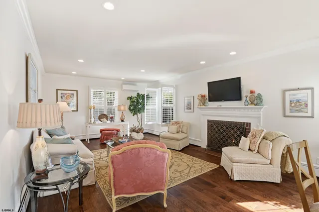 a living room with furniture fireplace and a flat screen tv