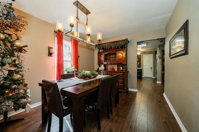 a kitchen with granite countertop a table and chairs in it