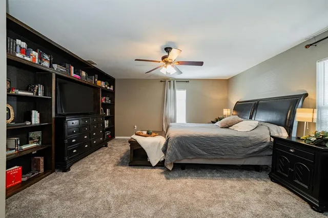 a bedroom with a bed cabinets and a walk in closet