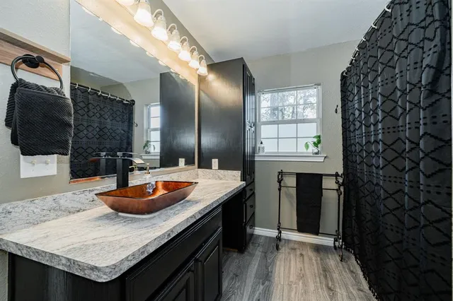 a kitchen with granite countertop a sink stove and cabinets